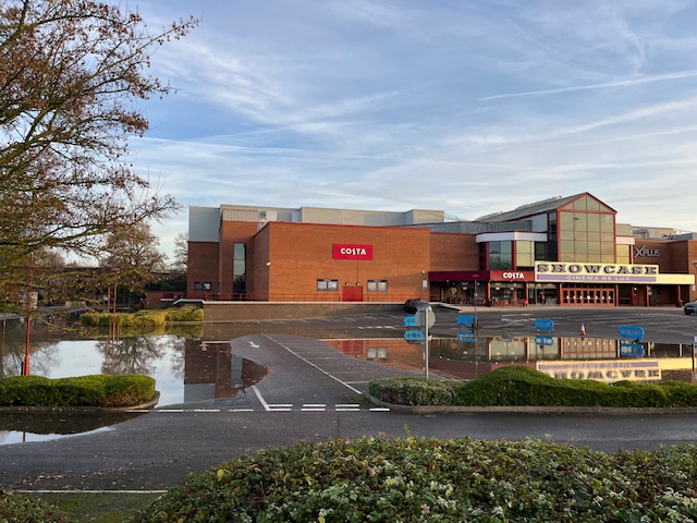 Showcase Carpark appears flooded at the riverside, and a large puddle in the centre has been fenced off.